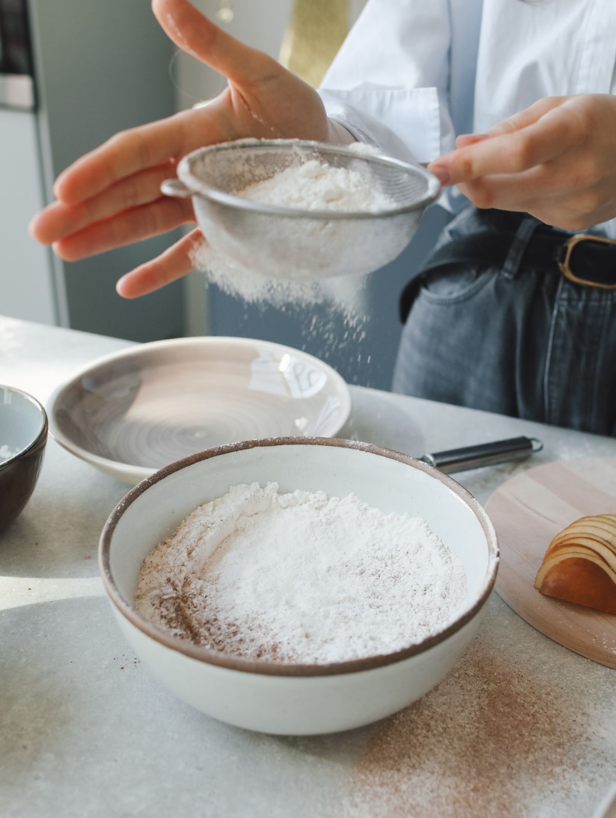 Flour being sifted into a mixing bowl