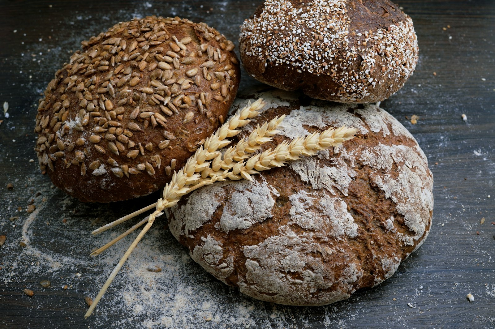 Three artisan loaves with wheat stalks