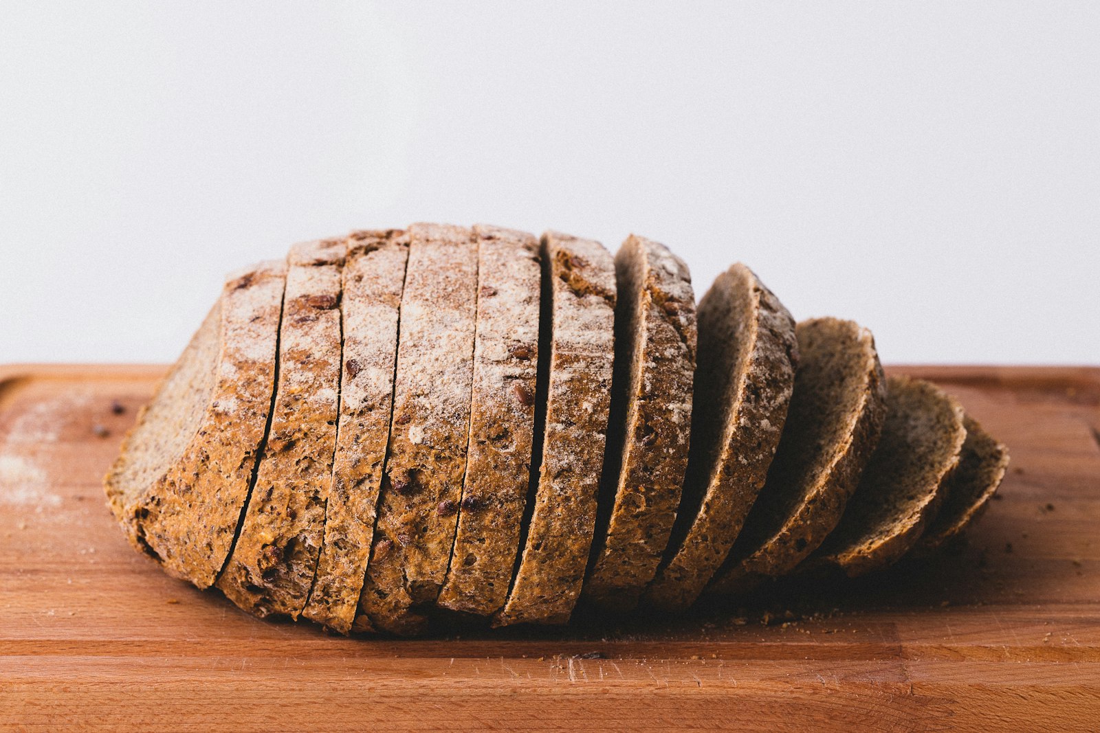 Sliced seeded loaf on a wooden board